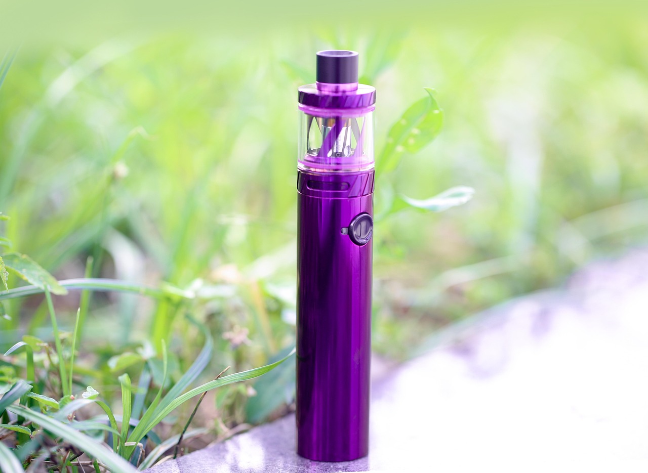 Rows of e-liquid bottles in assorted fruit and mint flavors on shelves